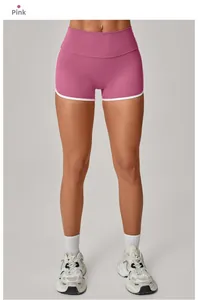 Detailed view of pink yoga shorts with high waist and white contrast binding edges