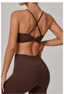 Detail of the twisted hem and criss-cross back design on a dark brown sports bra