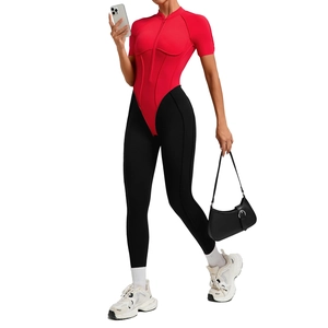 Women's athletic bodysuit with red zip collar top and black leggings for gym workout