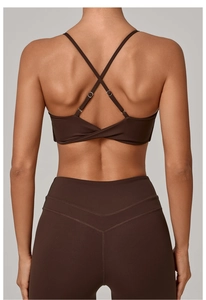 Close-up of brown sports bra with twisted back knot and V-seam high-waisted leggings