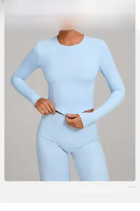 Detail view of high-elasticity sky blue yoga top with structural stitching for workout