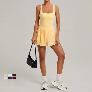 Women's backless athletic tennis dress with pleated skirt in vibrant yellow color