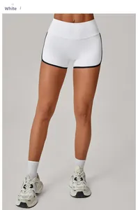 Detail of high-waist white yoga shorts with black contrast piping and tummy control