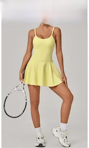 Lemon yellow tennis dress featuring cross-back straps and high waist A-line silhouette