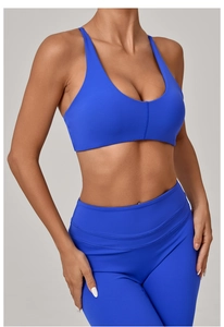 Detail of royal blue twist back sports bra and high waisted yoga leggings set