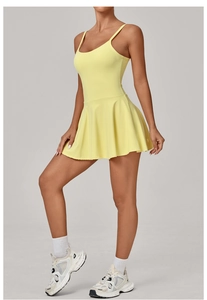 Detail of the pleated hem and slim fit of this pale yellow athletic tennis dress