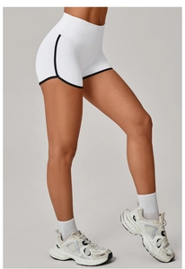 Macro detail of high-waist fitness shorts featuring black contrast trim and side seams