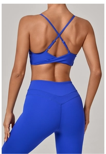 Detail showing the royal blue criss-cross back design and high-waisted yoga leggings