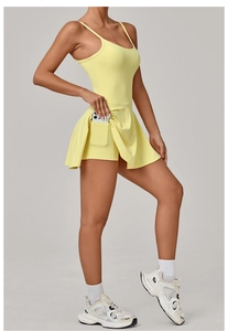 Detail of yellow tennis dress with built-in shorts and functional side phone pocket
