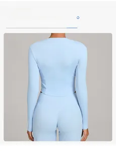 Detail view of light blue yoga top featuring a slim fit cut and extended hem design