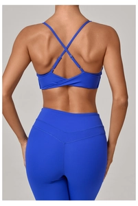 Detail view of royal blue back-cross sports bra and high-waist yoga pants set