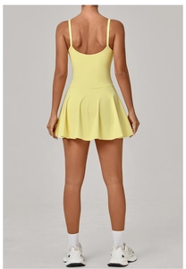 Back view of yellow tennis dress with pleated skirt and cross straps for golf