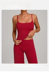 Detail of burgundy ribbed yoga set featuring a strappy sports top and high-waist leggings