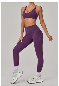 Detailed view of dark purple high-stretch yoga set with sports bra and high-waist leggings