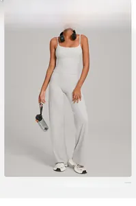 Detail of high-waisted yoga set with sports bra and wide-leg trousers in light grey