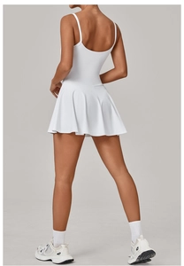 Detail of the white sports dress featuring thin straps and a deep U-shaped back design
