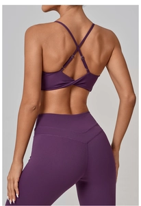 Detail of purple yoga bra featuring back twist knot and crisscross straps design
