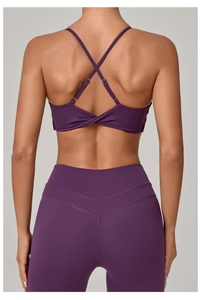 Close-up of cross-back straps and high-waisted seamless purple yoga bra and leggings set