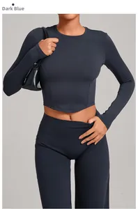 Detail view of skin-tight long sleeve yoga top and high waist leggings in dark teal
