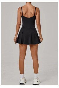 Rear view of black tennis dress with cross-back straps and pleated skirt hem detail