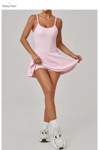 Detail view of baby pink athletic dress showing built-in safety shorts and elastic fabric