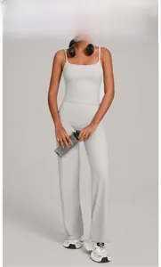 Detail shot of warm stone grey yoga set with slim strap tank top and high waist wide leg pants