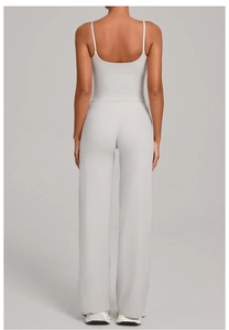 Back view of gray yoga set showing thin straps and high-waisted wide-leg trousers