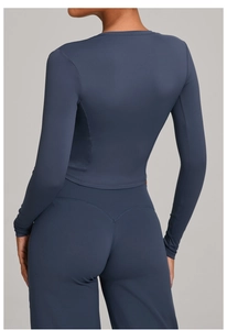 Close-up of heart-shaped stitching on navy blue high-waist yoga leggings back view