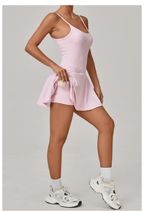 Detailed view of pink sports dress showing built-in shorts and functional tennis ball pocket
