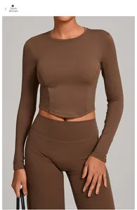 Detail of dark brown long-sleeve crop top and high-waist leggings workout set