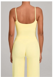 Detail view showing back design and elastic seams of yellow yoga vest and leggings set