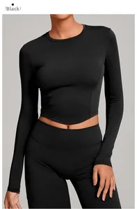 Detail of black long sleeve yoga top featuring curved hem and high stretch athletic fabric
