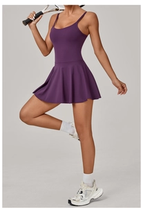 Macro shot of dark purple tennis dress with pleated skirt and athletic back design