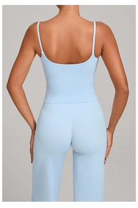 Detail view of light blue yoga set with strappy back top and high waist leggings