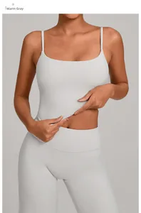 Detail of warm stone grey yoga set showing stretch fabric texture and slim straps