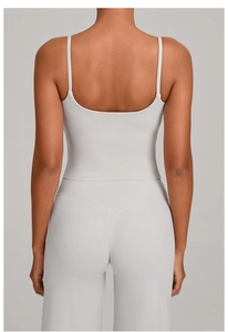 Detail view of the deep U-shaped back design on a beige high-stretch yoga set for women