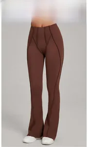 Detail showing high-waist coffee yoga flared pants with vertical stitching and smooth fabric