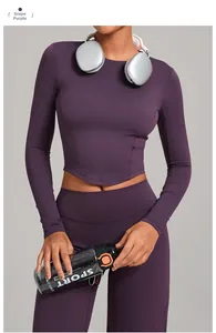 Detail of high-stretch grape purple yoga top featuring a curved hem and ribbed texture