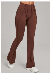 Detail of high waisted brown flared yoga pants with V-shaped stitching and slim leg design