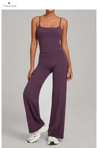 Detail view of the high-waisted yoga pants and thin strap top in deep grape purple color