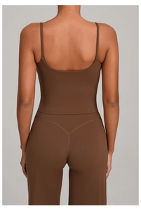 Detail of coffee brown open back sports bra and high-waisted leggings with V-shaped stitching