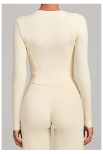 Rear view of cream long sleeve yoga top and high waist leggings in minimalist style