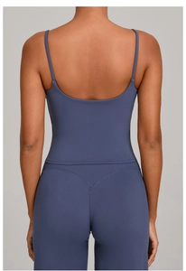 Detail of cross-back yoga top and high-waisted leggings in dusty blue matte fabric