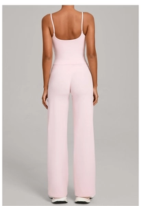 Detail view of pink yoga set back showing strappy tank top and high waist wide leg pants
