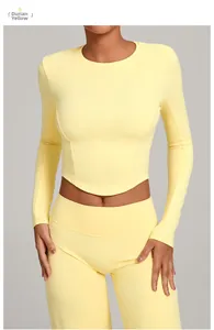 Close-up of seamless durian yellow yoga set including a long sleeve crop top and leggings