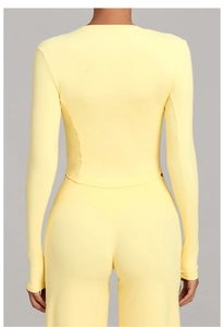 Detail view of high-elasticity pale yellow long-sleeve yoga set from the back perspective