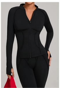 Détail de la veste de yoga noire ajustée avec col montant et passants de pouce