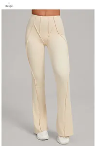 Detail view of beige high-waisted flare yoga pants with decorative stitching patterns