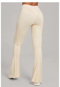 Detail of high waisted cream flare yoga pants showing V-shaped back seam and seam lines