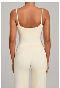 Detail of cross-back yoga tank top showing seamless beige fabric and thin straps